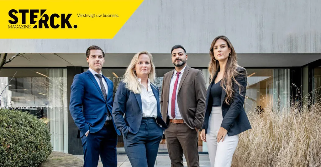 Four people in formal outfits in front of a building — Le Grand & Associates